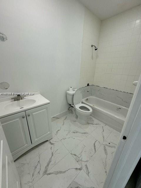 full bathroom featuring vanity, toilet, and tiled shower / bath