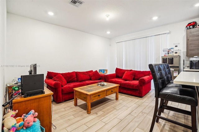 living room with light hardwood / wood-style flooring