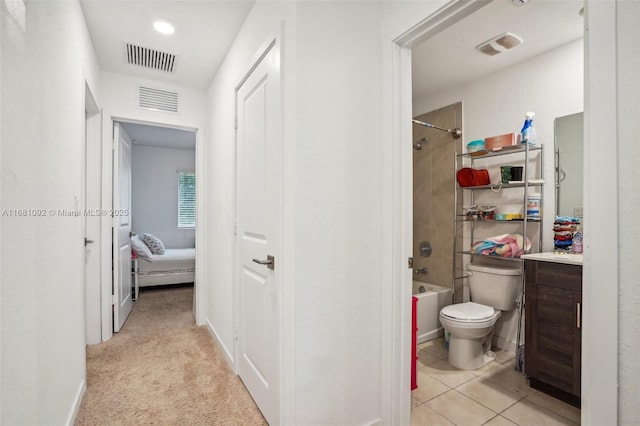 full bathroom featuring tiled shower / bath combo, toilet, tile patterned floors, and vanity