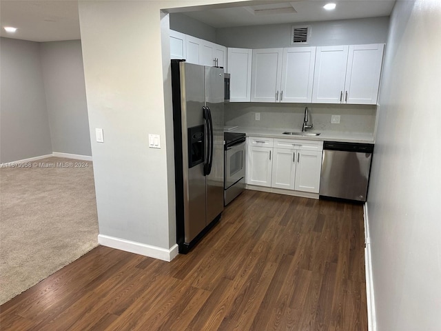 kitchen with dark colored carpet, sink, white cabinetry, and stainless steel appliances