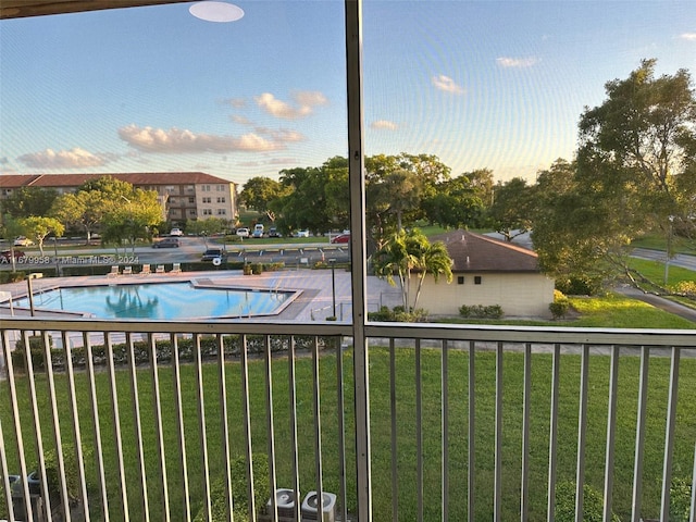 view of pool featuring a yard