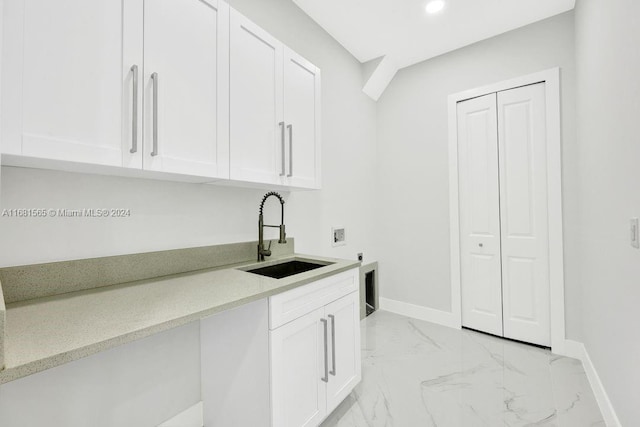 clothes washing area with washer hookup, electric dryer hookup, cabinets, and sink