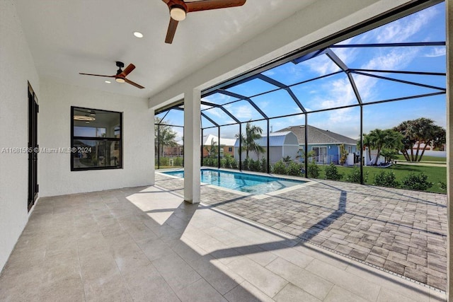 view of pool featuring ceiling fan, a lanai, and a patio area