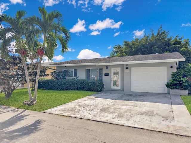 single story home with a garage and a front lawn