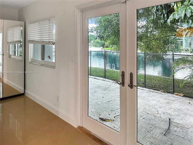 entryway with french doors and a water view