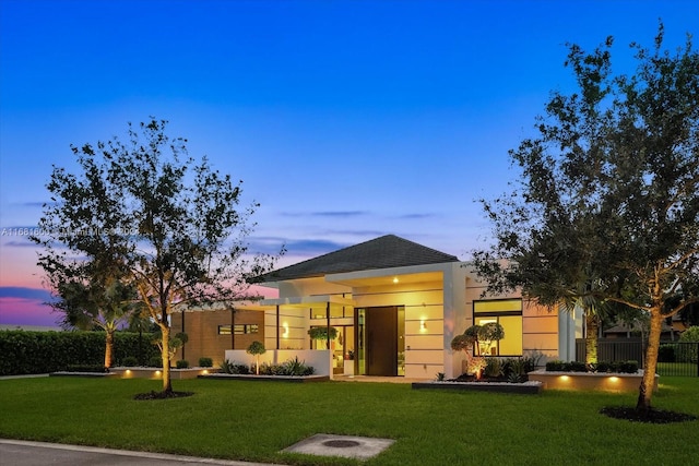 view of front of house with a yard