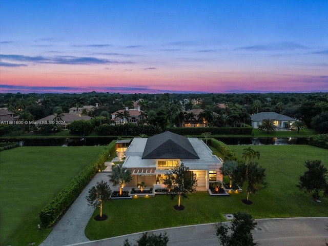 aerial view at dusk with a water view