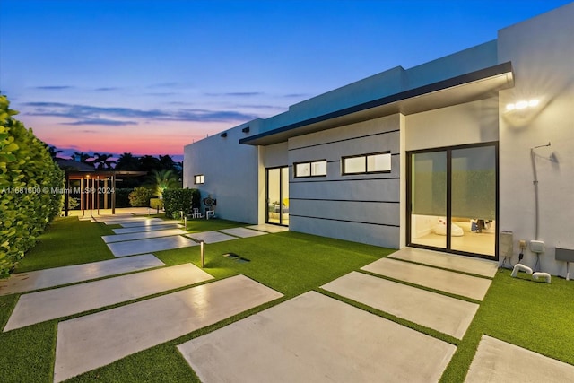 yard at dusk with a patio