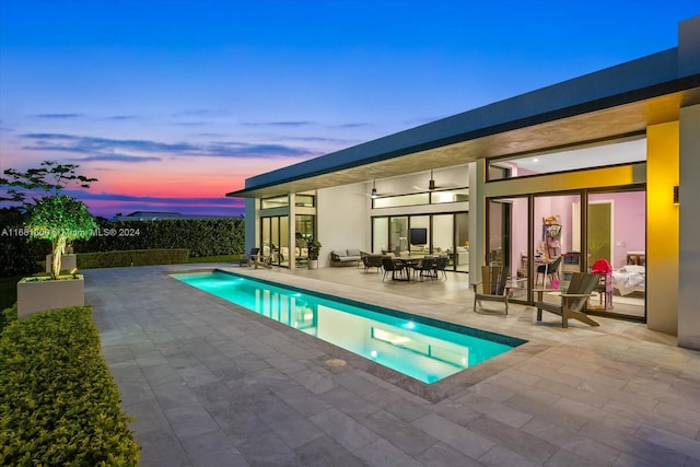 view of swimming pool with a patio area and ceiling fan