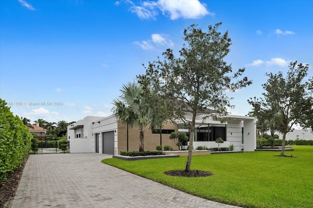 view of front facade with a front yard and a garage