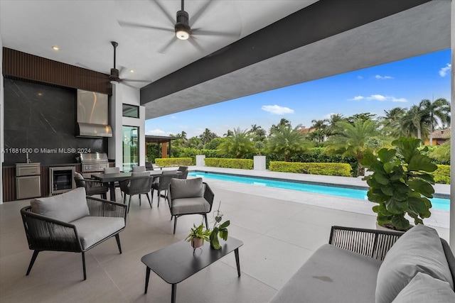 view of patio featuring area for grilling and ceiling fan