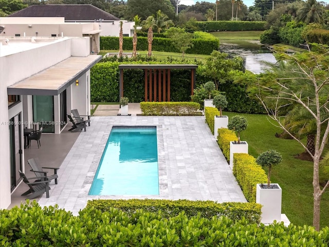 view of swimming pool featuring a patio area and a yard