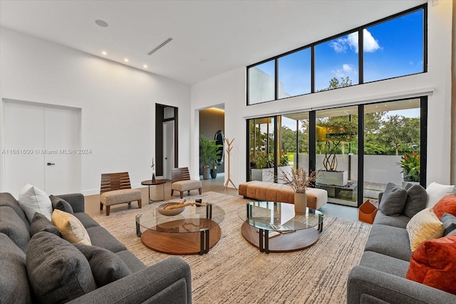 living room featuring a towering ceiling