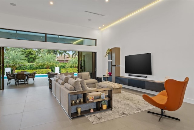 tiled living room with a high ceiling