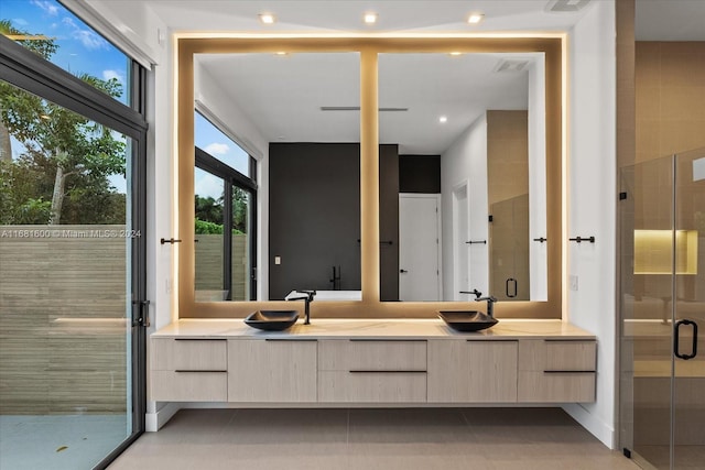 bathroom featuring vanity and an enclosed shower