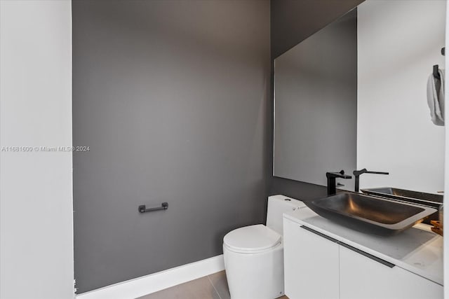 bathroom with vanity, toilet, and tile patterned floors