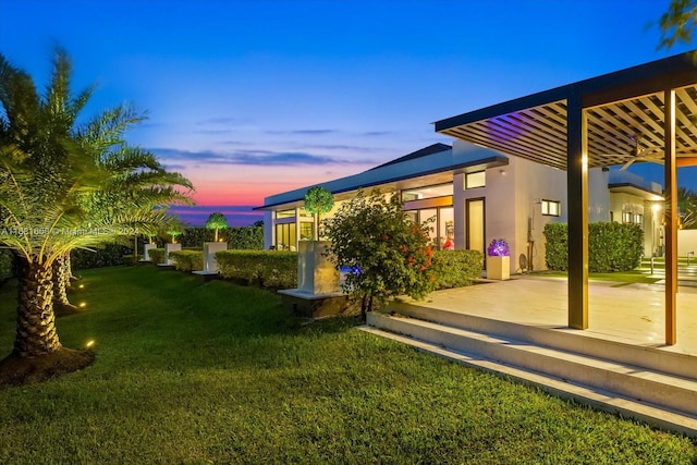 yard at dusk with a patio