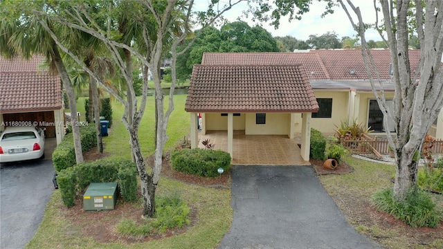 view of front of home with a front lawn and a carport