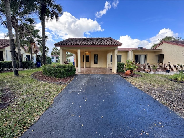 mediterranean / spanish house with a front lawn