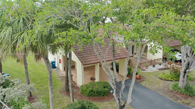 view of home's exterior featuring a yard and a carport