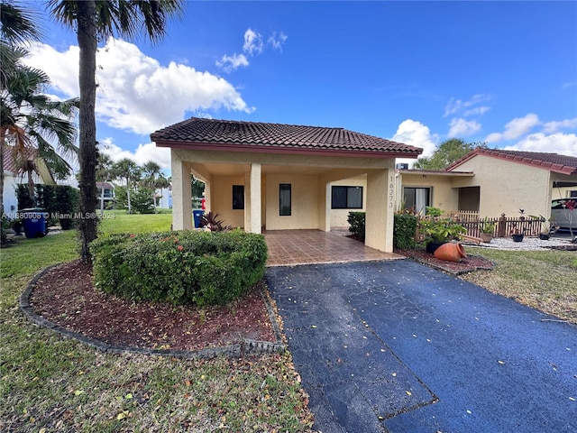 mediterranean / spanish house with a front yard