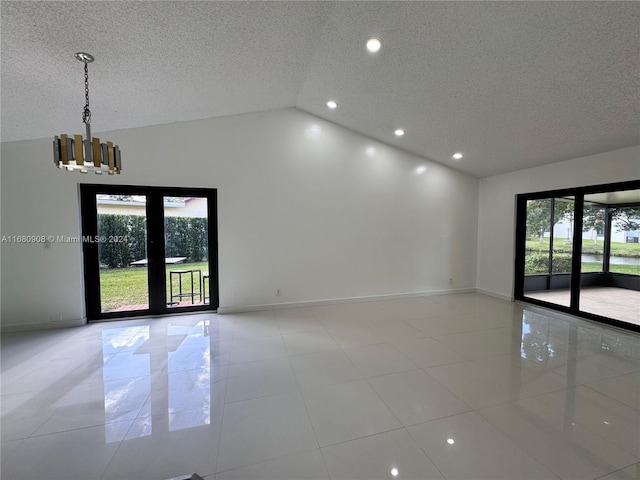 tiled spare room with high vaulted ceiling, a notable chandelier, and a textured ceiling