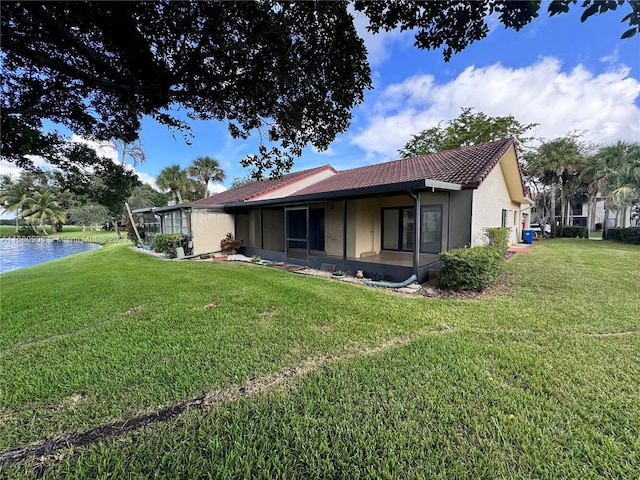 rear view of property with a lawn