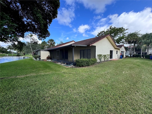 view of property exterior featuring a yard and a water view