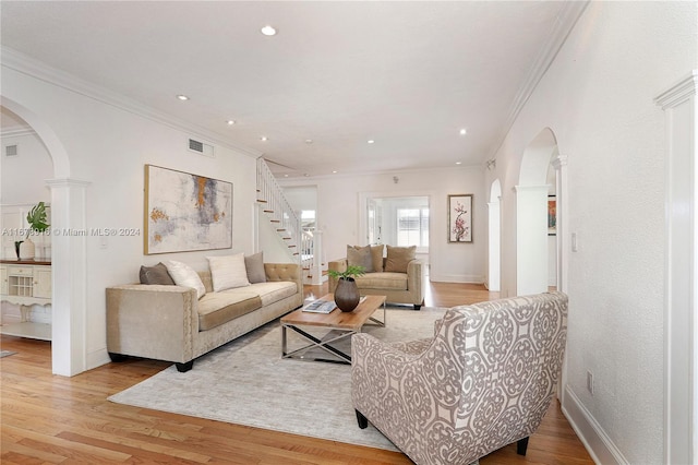 living room featuring ornamental molding and light wood-type flooring