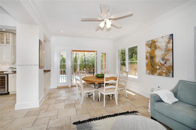 dining space featuring wine cooler, ornamental molding, and ceiling fan