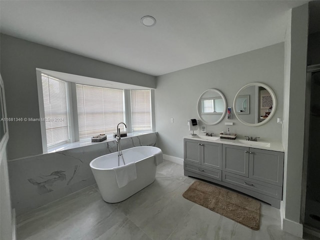 bathroom with vanity and a tub to relax in