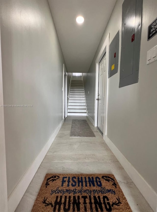 hallway featuring electric panel and wood-type flooring