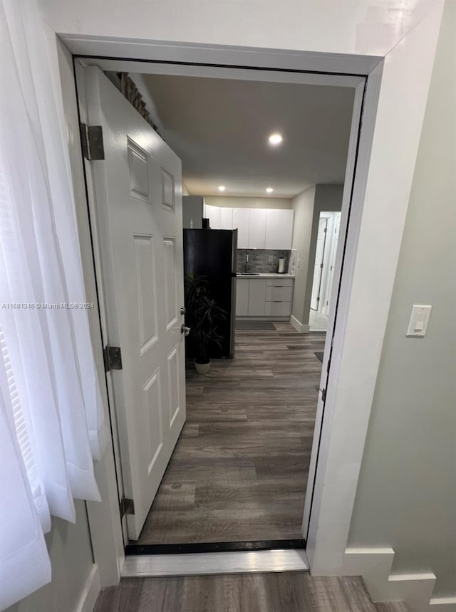 corridor with sink and dark hardwood / wood-style flooring