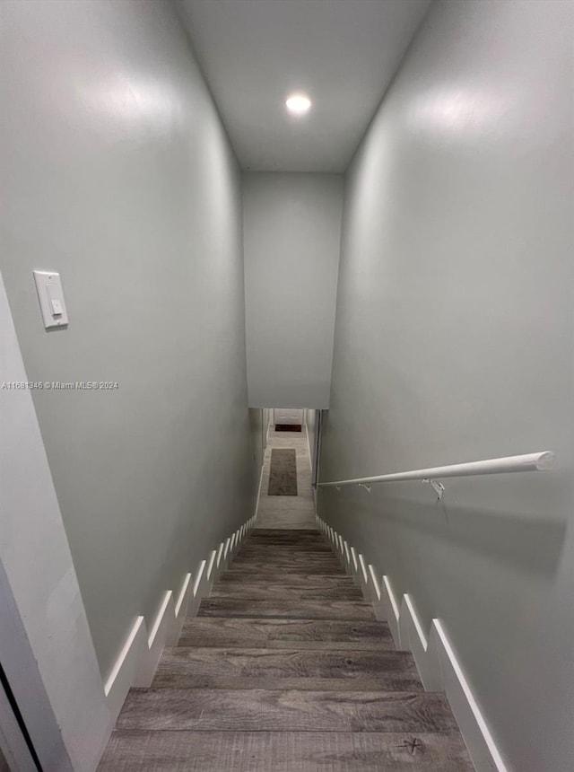 stairs with hardwood / wood-style floors