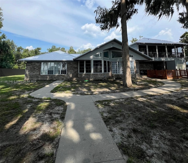 back of property featuring a sunroom