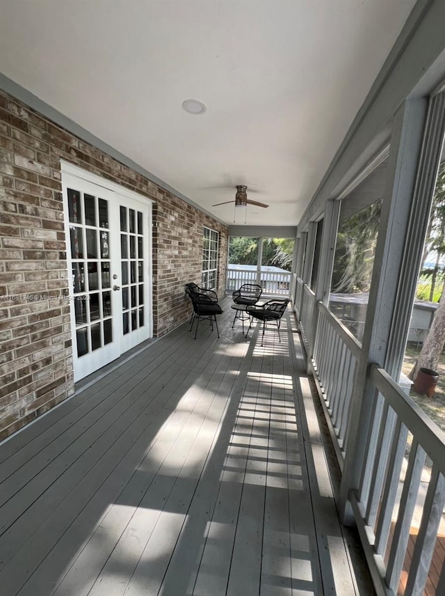 wooden terrace with french doors and ceiling fan