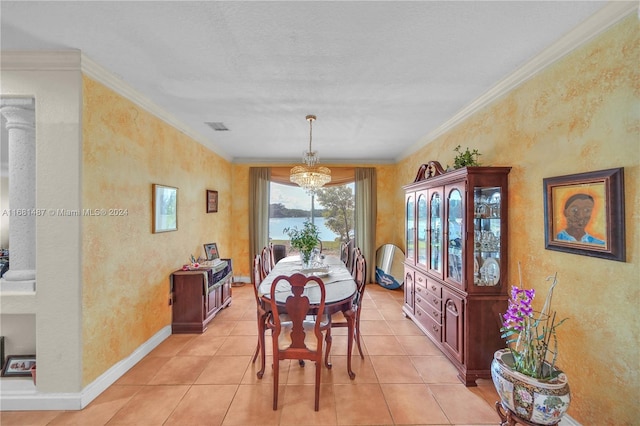 tiled dining area featuring crown molding and an inviting chandelier