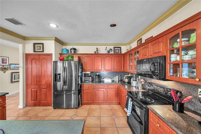 kitchen featuring a textured ceiling, black appliances, light tile patterned floors, and crown molding