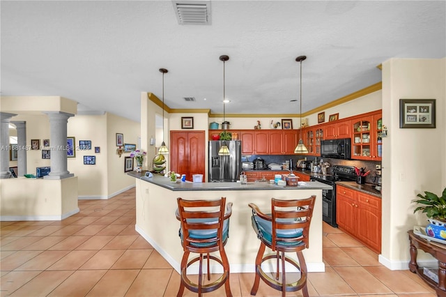 kitchen featuring light tile patterned flooring, ornate columns, black appliances, and tasteful backsplash