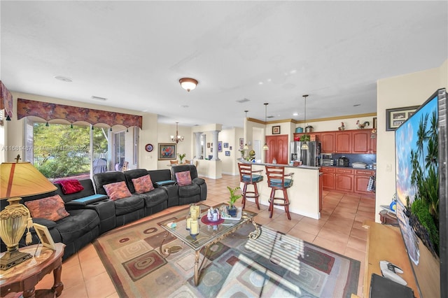 tiled living room with a chandelier and crown molding