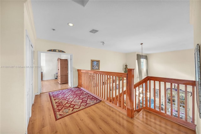 hallway with light hardwood / wood-style flooring