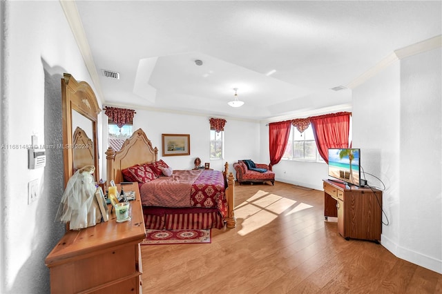 bedroom with hardwood / wood-style flooring and crown molding