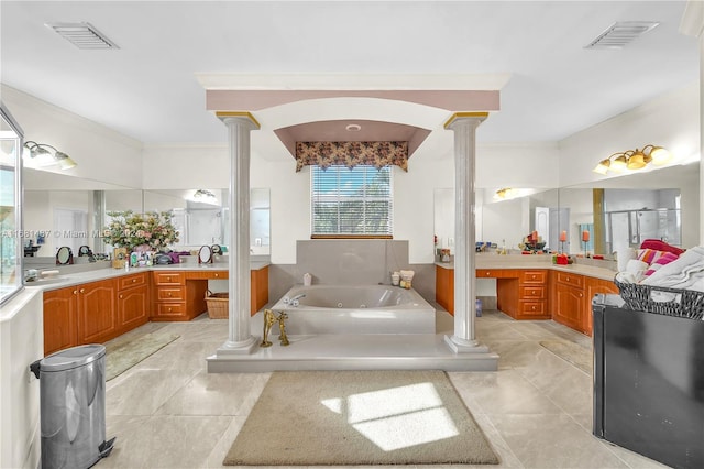 bathroom featuring ornate columns, tile patterned flooring, a washtub, and vanity