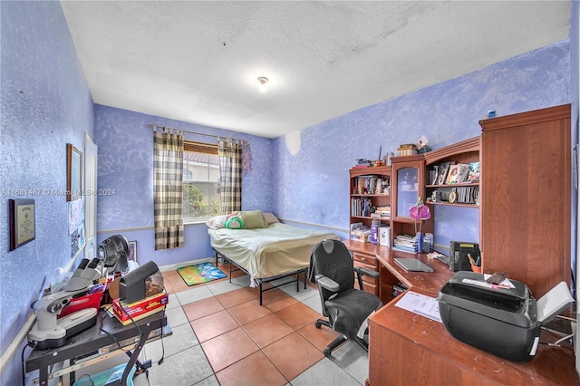 bedroom with a textured ceiling and light tile patterned flooring