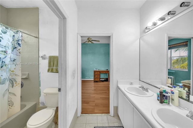 full bathroom featuring shower / bath combo with shower curtain, tile patterned floors, toilet, vanity, and ceiling fan