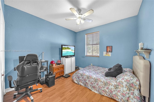 bedroom featuring hardwood / wood-style flooring and ceiling fan