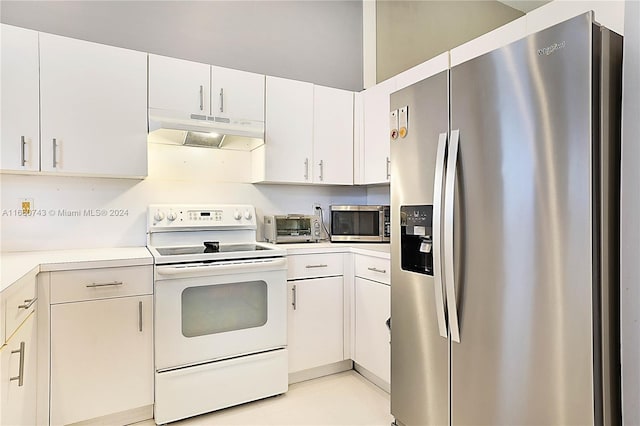 kitchen featuring light tile patterned flooring, white cabinetry, and appliances with stainless steel finishes