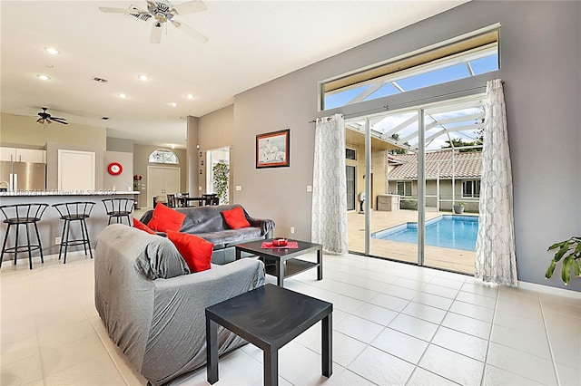 living room with ceiling fan and light tile patterned flooring