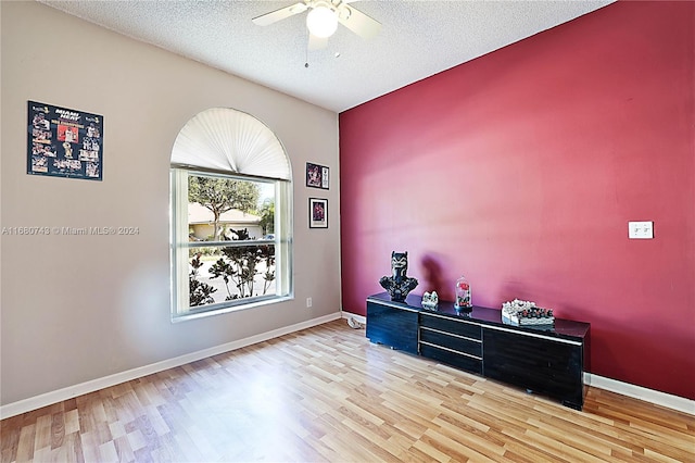 miscellaneous room with wood-type flooring, a textured ceiling, and ceiling fan