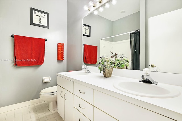 bathroom with a shower with shower curtain, tile patterned floors, vanity, and toilet